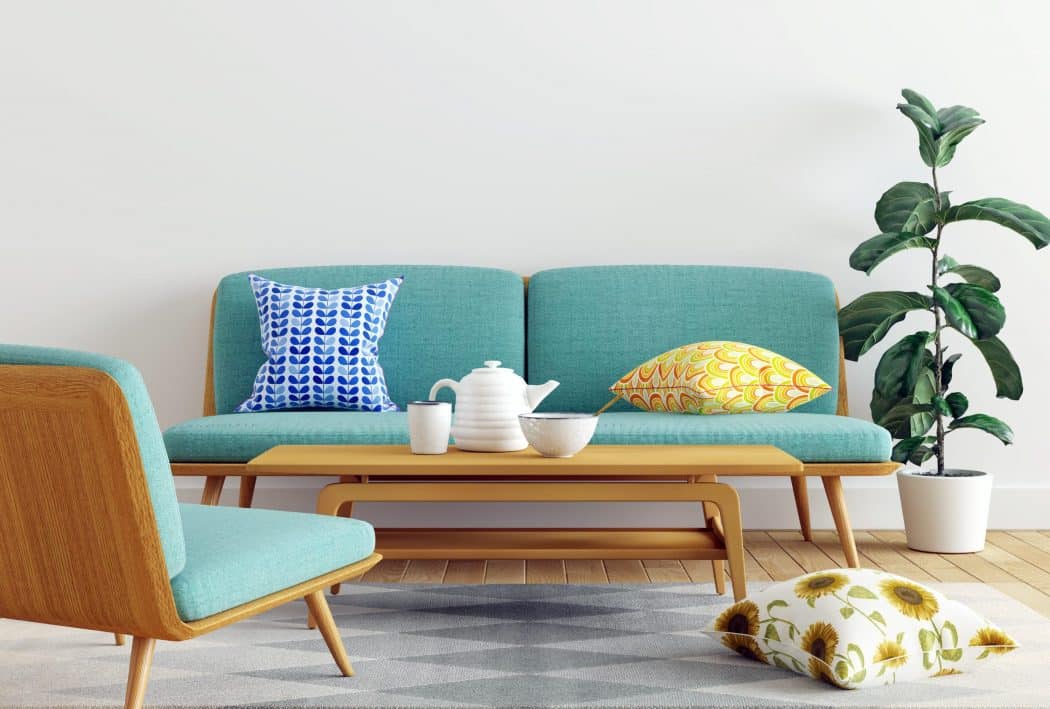 5 rules in Interior Design that we are begging you to break! blue sofa with blue and yellow pillows - 5 rules in Interior Design that we are begging you to break!