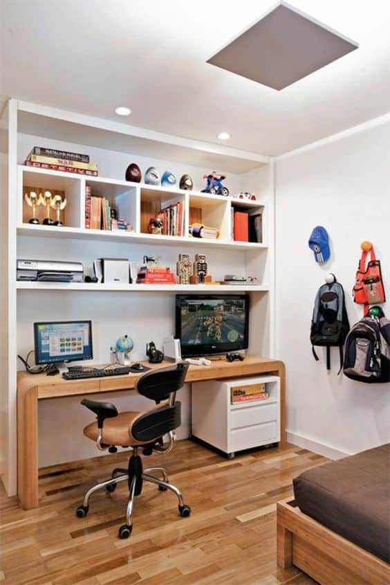 Escritório com Biblioteca: 25 exemplos para e crie um ambiente funcional e inspirador. Veja as sugestões! 20 Muitas vezes, o escritório é instalado no próprio quarto. Nesses casos, podemos incluir uma pequena biblioteca associada a estante.