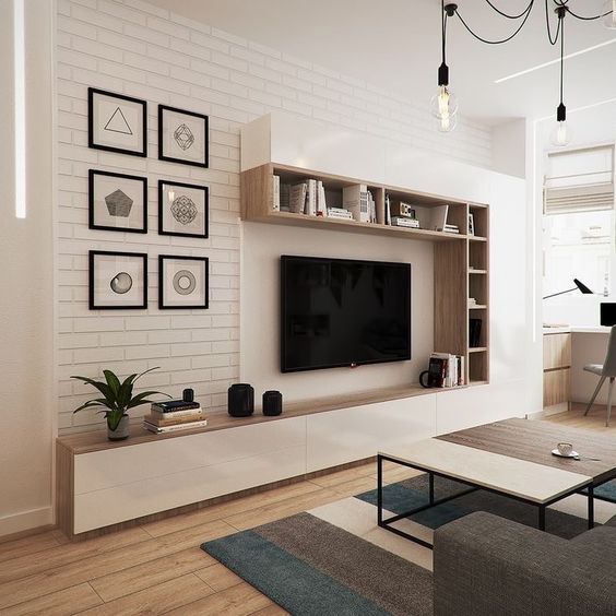 Para valorizar o espaço sem pesar no ambiente, o rack da inspiração a seguir foi pensado em um formato aberto, incluindo partes suspensas com gavetas e área aparente para incluir decorações.