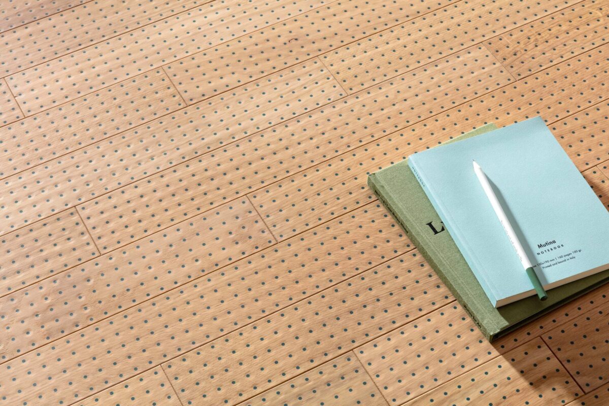 Irmãos 10 Bouroullec: conheça a dupla de designers franceses que colabora com a Mutina 5 Piso que reproduz madeira com pontos azuis em baixo-relevo. Há cadernos azuis sobre ele (Foto: Mutina)