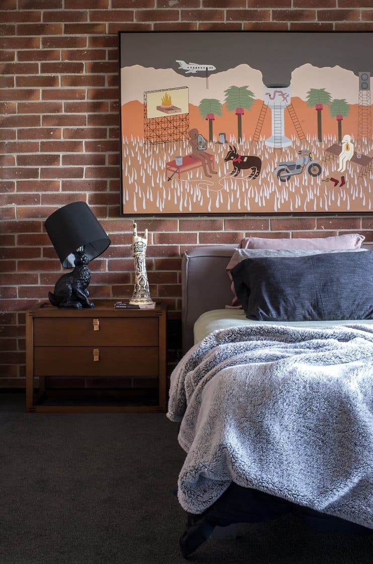 Revestimento para parede de quarto: Dicas para uma decoração moderna 5 O tijolo aparente dá um toque industrial e rústico ao quarto. Pode ser uma opção interessante usar pedra natural também. (Projeto: Paula Sizinando)