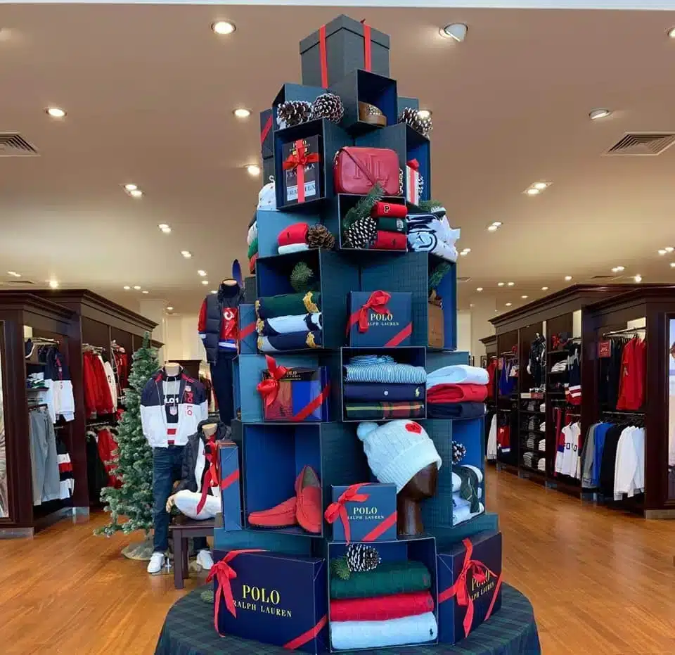 9 Dicas Para Montar uma Vitrine de Natal Encantadora 10 Decoração de loja com a árvore de Natal na parede, otimizando o espaço.